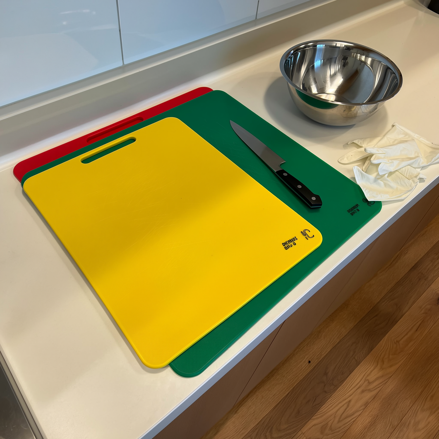 Pisică domestică lângă un bol cu hrană crudă pe podeaua bucătăriei